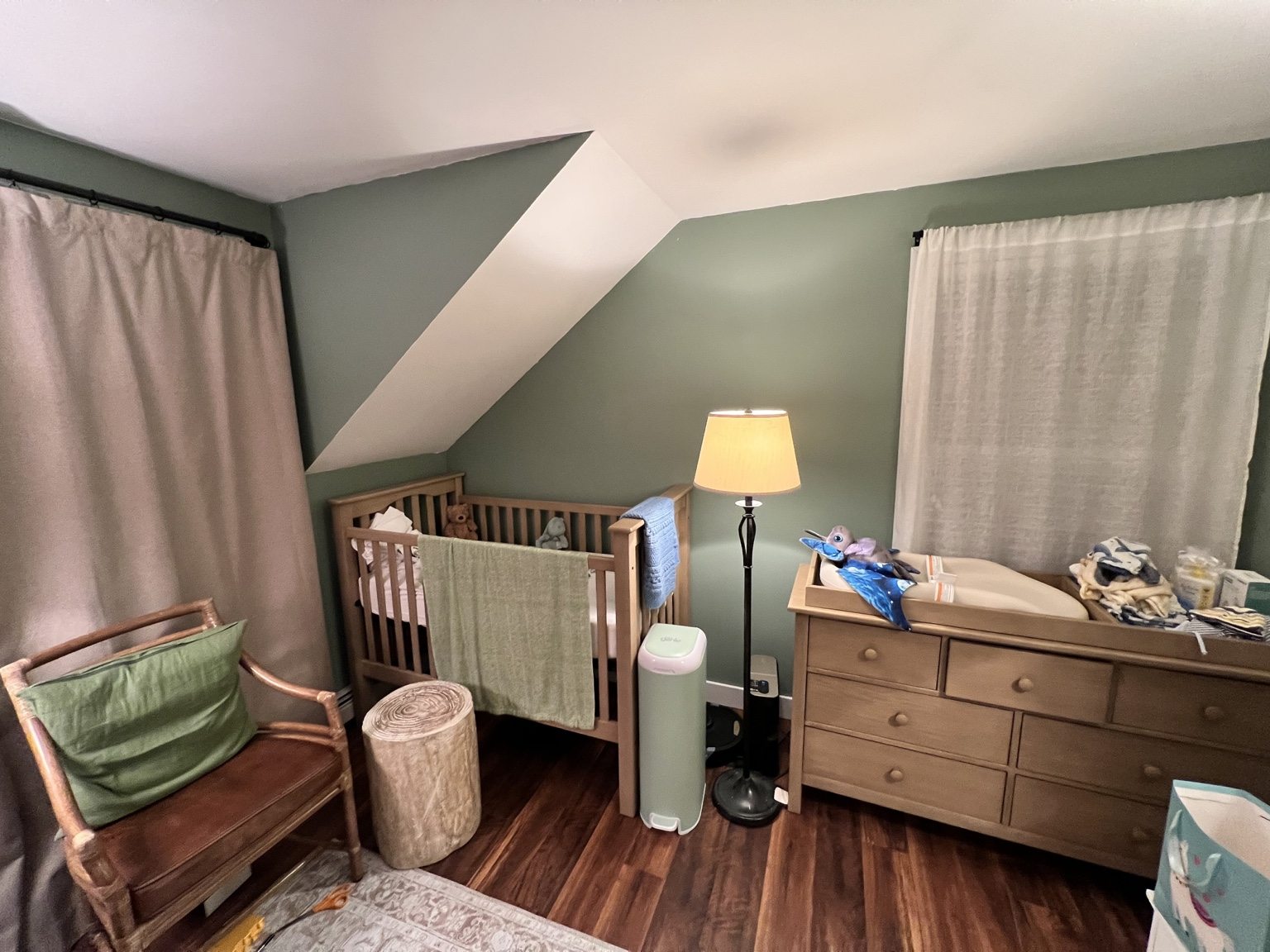 Bedroom with green walls and wood floors