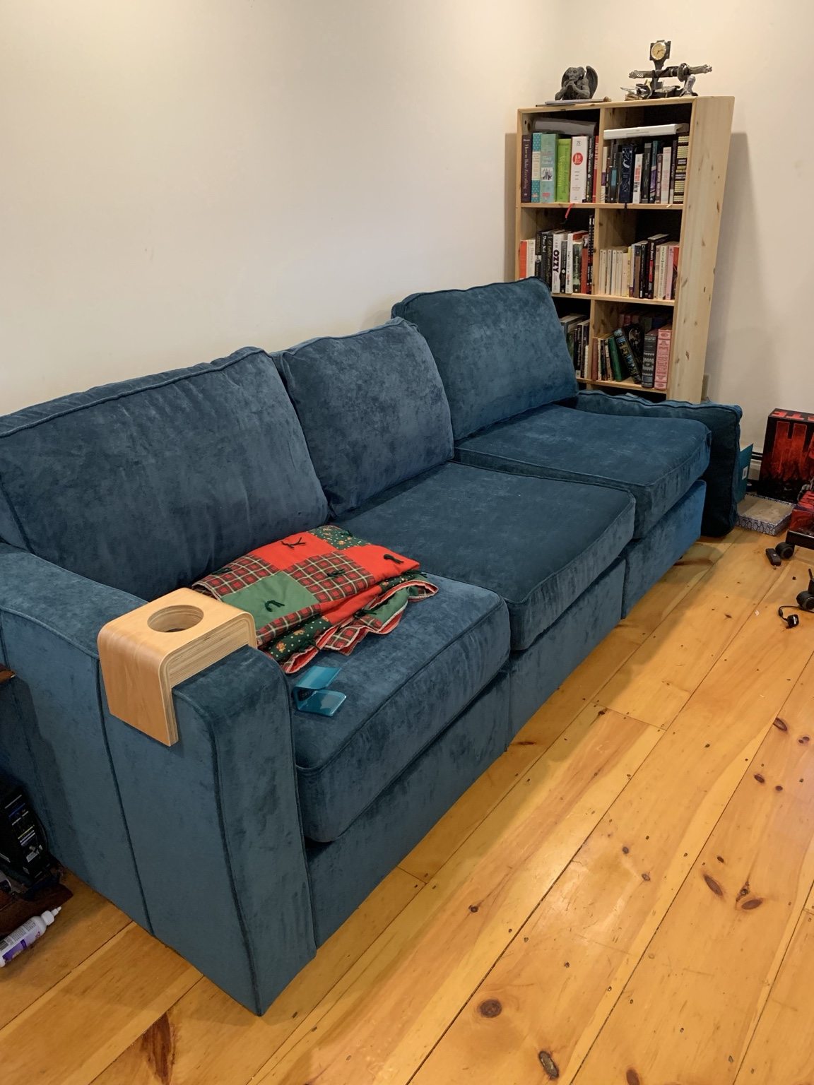Living space with blue sofa and wood floors
